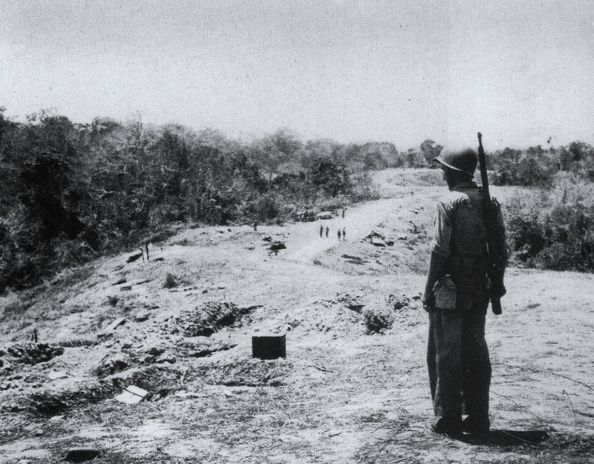Black and white archival photo of World War II soldiers positioned on the Bloody Ridge, with rifles and military gear, during the Guadalcanal campaign